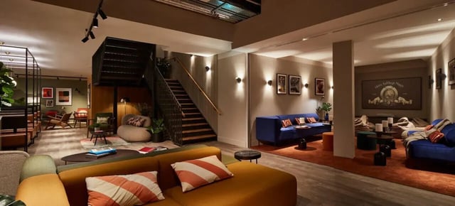Sofa chairs tables and stairs living room at Tribu Kingston in Kingston Upon Thames Student Accommodation