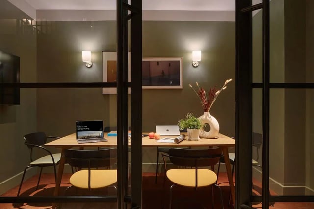Study area with table chairs laptop and vase Study area at Tribu Kingston in Kingston Upon Thames Student Accommodation
