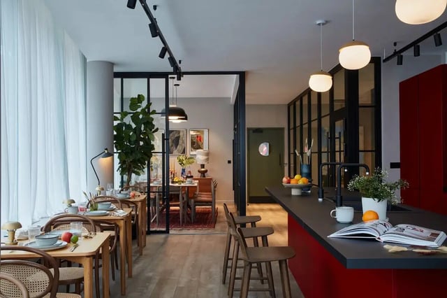 Dining tables with chairs and kitchen island kitchen at Tribu Kingston in Kingston Upon Thames Student Accommodation