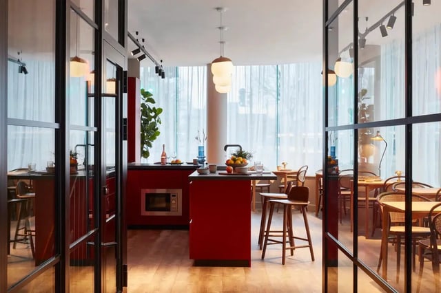 Red island microwave stools and dining tables kitchen at Tribu Kingston in Kingston Upon Thames Student Accommodation