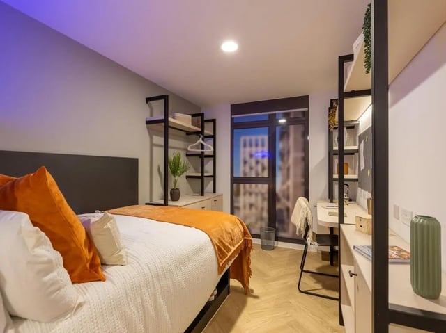 Bed desk shelves plant and window bedroom at Arcadian in Nottingham Student Accommodation