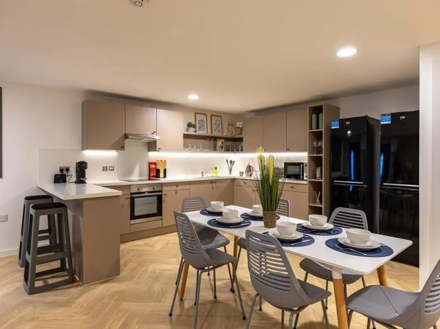 Modern kitchen with dining table and chairs kitchen at Arcadian in Nottingham Student Accommodation