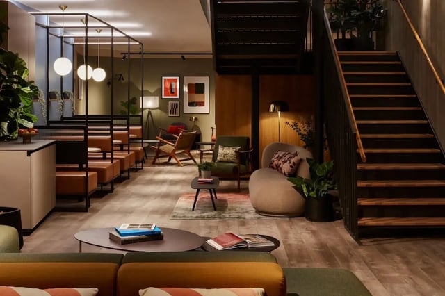 Modern common area with seating and stairs communal area at Tribu Kingston in Kingston Upon Thames Student Accommodation