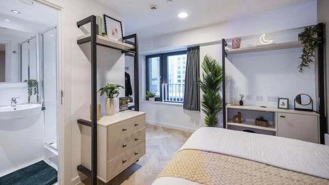 Bed dresser shelf and bathroom bedroom at Arcadian in Nottingham Student Accommodation