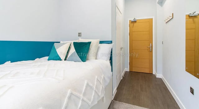 Bed with teal headboard and pillows bedroom at Urban Student Village in Coventry Student Accommodation