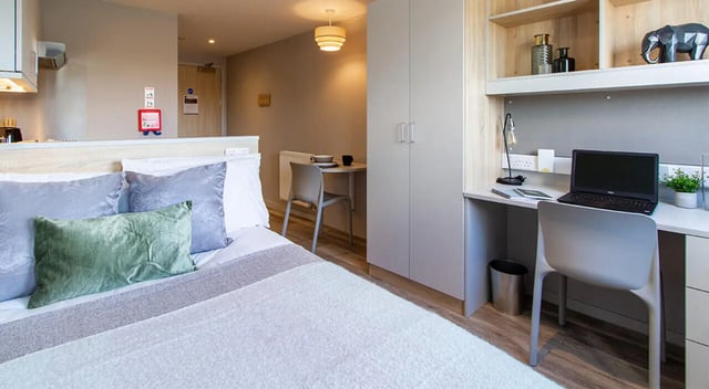 Bed desk wardrobe and dining area bedroom at Renslade House in Exeter Student Accommodation