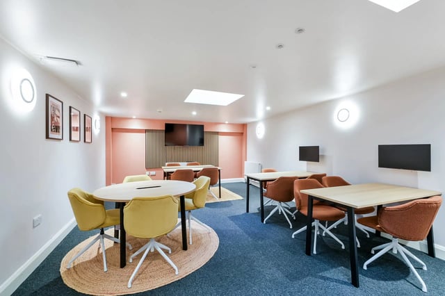 Tables and chairs communal study area at AXO Waterloo in London Student Accommodation