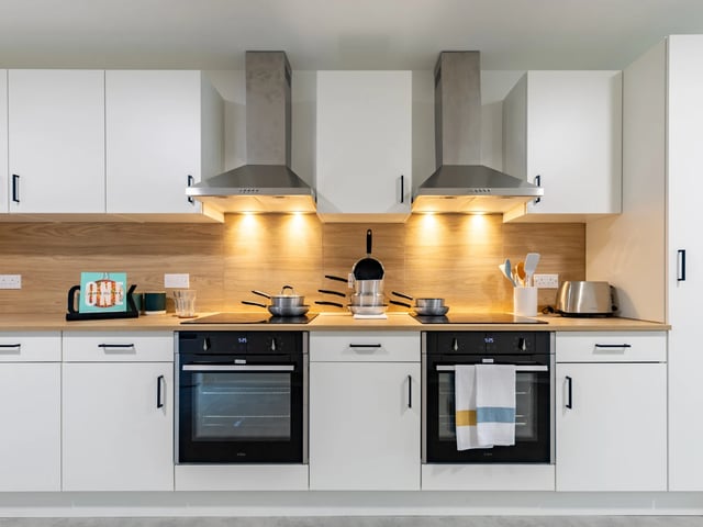 White cabinets two ovens and toaster kitchen at Venti House in London Student Accommodation