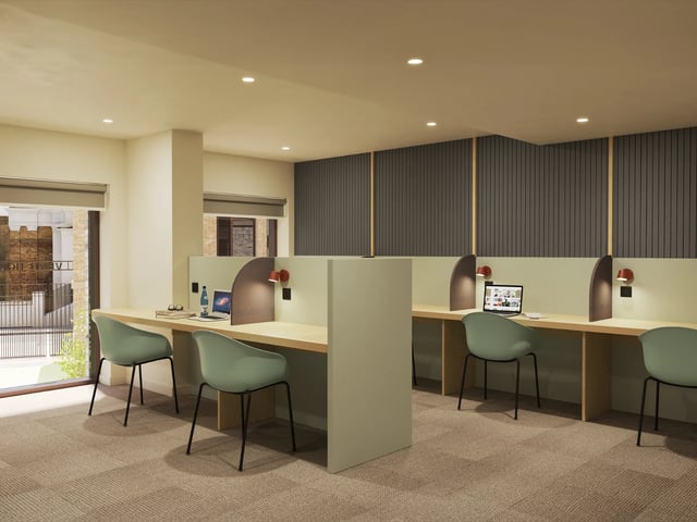 Desks with chairs laptops and lamps study area at Venti House in London Student Accommodation