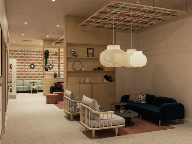 Seating shelving lamps and patterned wall communal living room at Venti House in London Student Accommodation