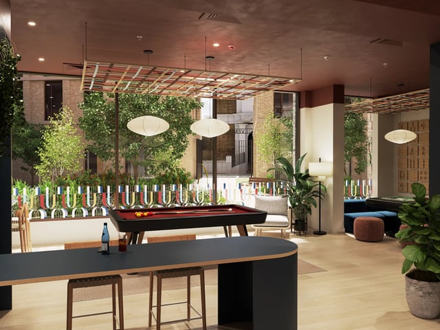 Pool table lounge chairs and plants communal area at Venti House in London Student Accommodation