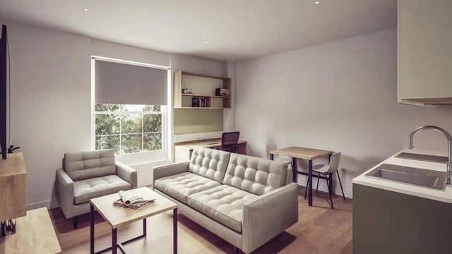 Sofa armchair desk shelving kitchen living room at St Chads Student Village in Birmingham Student Accommodation