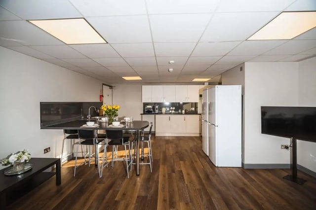 Kitchen area with island and seating living area at The Junxion Lincoln in Lincoln Student Accommodation