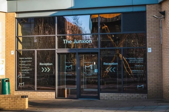Glass entrance with reception signs exterior at The Junxion Lincoln in Lincoln Student Accommodation