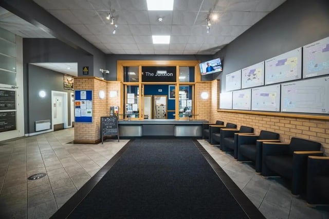 Reception desk with chairs and floor plans. Lobby interior at The Junxion Lincoln in Lincoln Student Accommodation