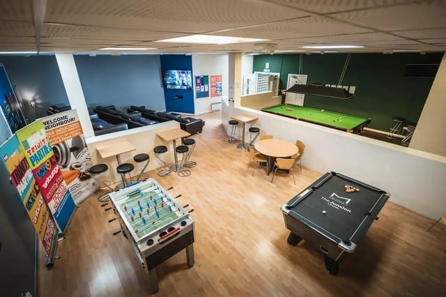 Foosball pool tables lounge sofas and tables common area at The Junxion Lincoln in Lincoln Student Accommodation