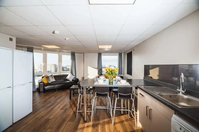 Sofas fridge dining table kitchen living area at The Junxion Lincoln in Lincoln Student Accommodation