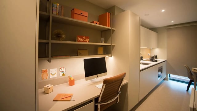 Desk with computer and kitchen area kitchen at Beechenhurst House in Birmingham Student Accommodation