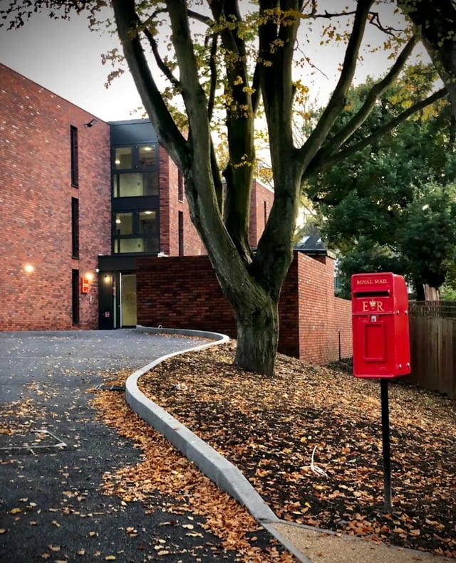 Brick building entrance with red post box exterior at Beechenhurst House in Birmingham Student Accommodation