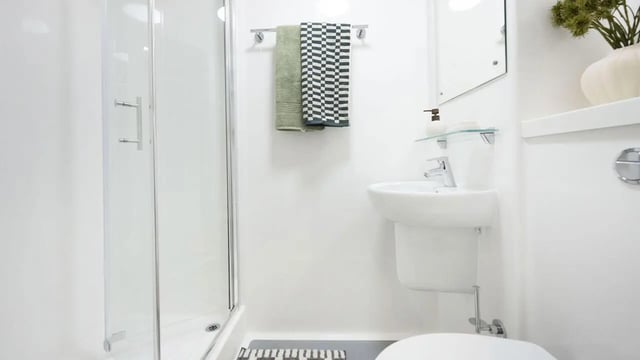 Shower sink mirror soap dispenser towels bathroom at St Vincent Studios in Glasgow Student Accommodation