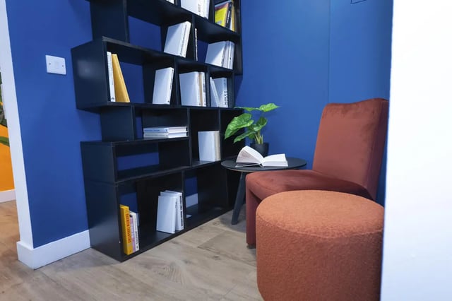 Bookshelf chair and ottoman common area at Aparto Arbury Court in Kingston Upon Thames Student Accommodation