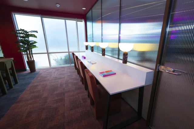 Long desk with chairs lamps and books study area at Aparto Arbury Court in Kingston Upon Thames Student Accommodation