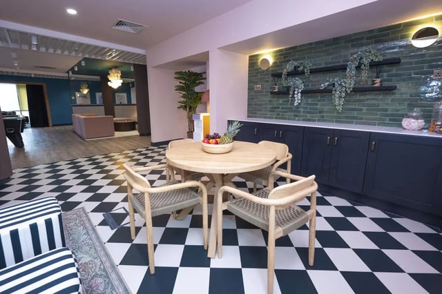 Round table chairs fruit bowl black cabinets communal area at Aparto Arbury Court in Kingston Upon Thames Student Accommodation