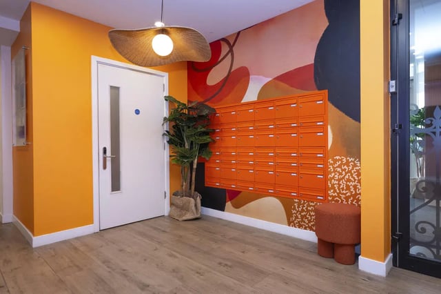 Orange mailboxes plant and stool hallway at Aparto Arbury Court in Kingston Upon Thames Student Accommodation