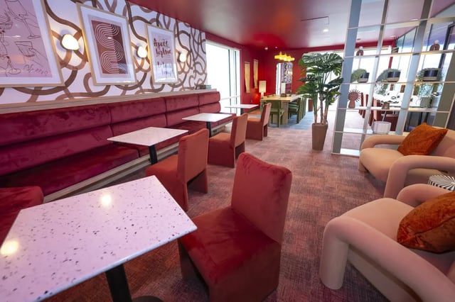 Red velvet booths tables chairs plants living room at Aparto Arbury Court in Kingston Upon Thames Student Accommodation