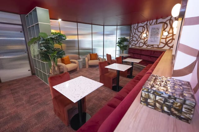 Seating tables plant and chairs communal area at Aparto Arbury Court in Kingston Upon Thames Student Accommodation