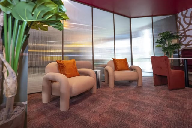 Two soft chairs with orange pillows lounge area at Aparto Arbury Court in Kingston Upon Thames Student Accommodation