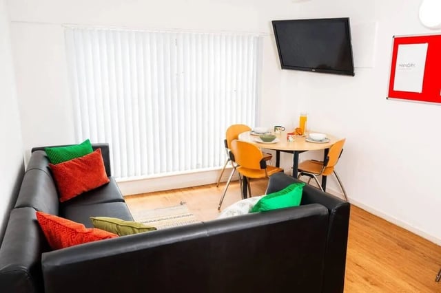 Black sofa dining table with chairs living room at Marybone Student Village 1 in Liverpool Student Accommodation