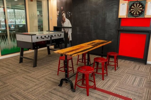 Foosball table, dartboard, and table with stools lounge area at Marybone Student Village 2 in Liverpool Student Accommodation