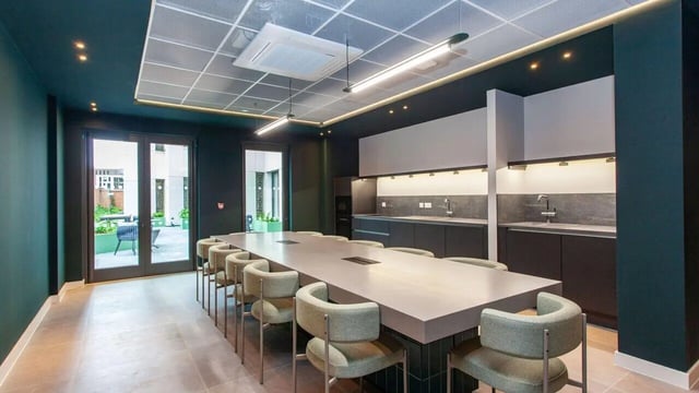 Large communal table with chairs modern kitchen area common room at Sheares Hall in Newcastle Upon Tyne Student Accommodation
