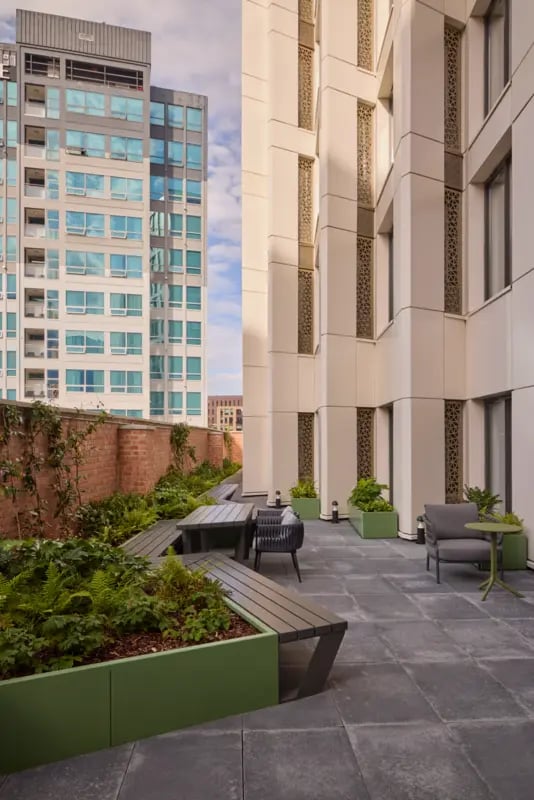Seating and tables in a courtyard living space at Sheares Hall in Newcastle Upon Tyne Student Accommodation