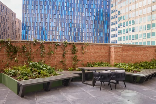 Outdoor seating area with table and benches exterior at Sheares Hall in Newcastle Upon Tyne Student Accommodation