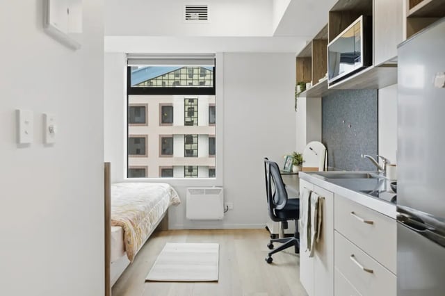 Bed desk kitchenette and fridge studio apartment at Mayoral Drive Student Accommodation in Auckland Student Accommodation