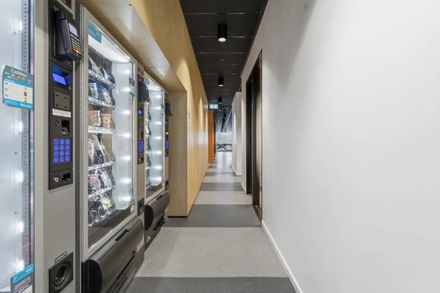 Vending machines line a modern hallway common area at Mayoral Drive Student Accommodation in Auckland Student Accommodation