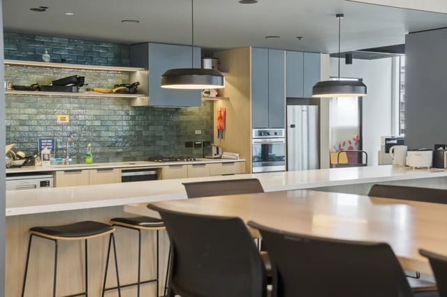 Modern kitchen with stainless steel appliances and seating Kitchen at Mayoral Drive Student Accommodation in Auckland Student Accommodation