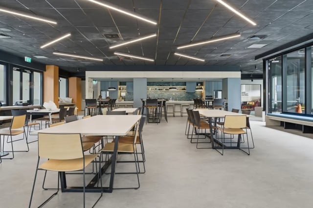 Dining tables with chairs kitchen and seating area communal space at Mayoral Drive Student Accommodation in Auckland Student Accommodation
