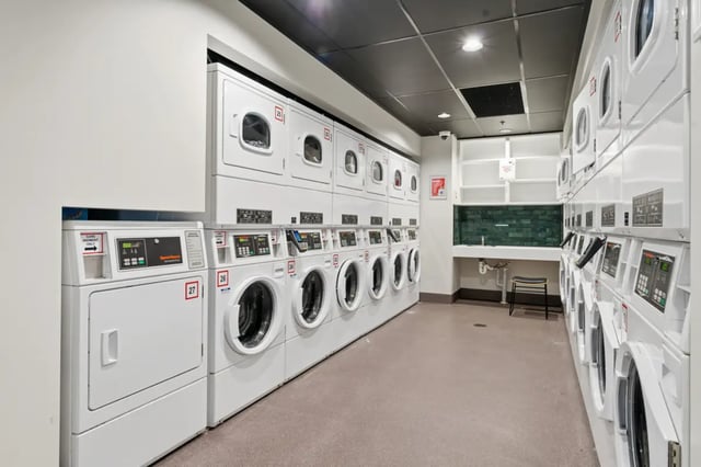 Stacked washers dryers and sink area laundry room at Mayoral Drive Student Accommodation in Auckland Student Accommodation