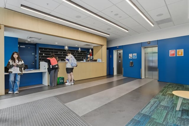 Students at reception counter near elevators lobby at Mayoral Drive Student Accommodation in Auckland Student Accommodation