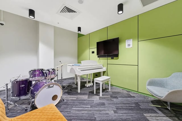Drum set piano TV and chair recreation area at Mayoral Drive Student Accommodation in Auckland Student Accommodation
