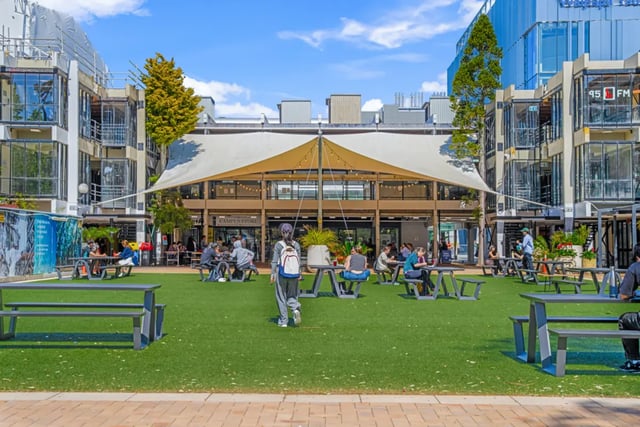 Students sitting at picnic tables outdoor living area at Mayoral Drive Student Accommodation in Auckland Student Accommodation