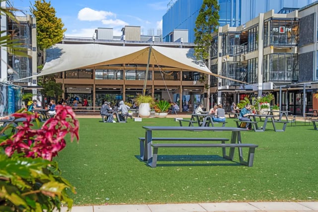 People seated at picnic tables outdoor dining area at Mayoral Drive Student Accommodation in Auckland Student Accommodation