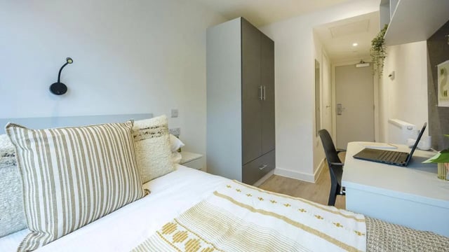 Bed desk wardrobe and door bedroom at Sheares Hall in Newcastle Upon Tyne Student Accommodation
