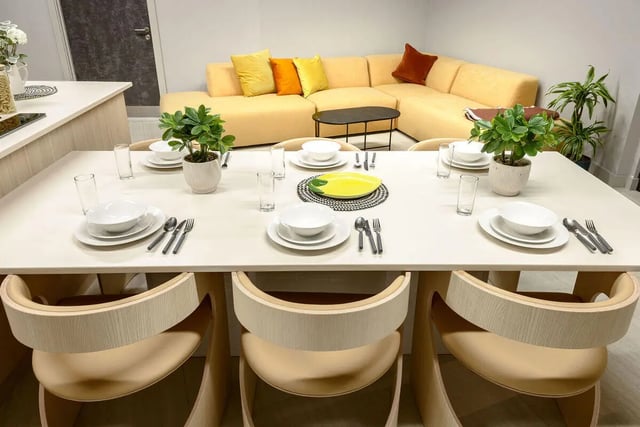 Dining table chairs sofa plants kitchen area at True Nottingham in Nottingham Student Accommodation