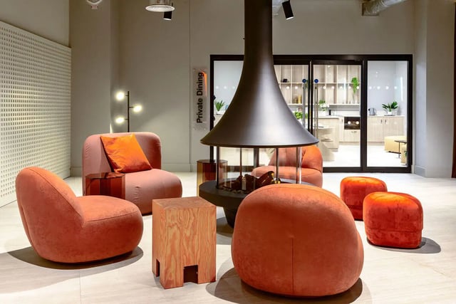 Modern seating with fireplace kitchen view living room at True Nottingham in Nottingham Student Accommodation