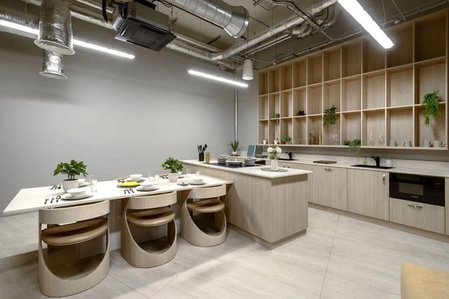 Dining table with chairs and kitchen counter kitchen at True Nottingham in Nottingham Student Accommodation