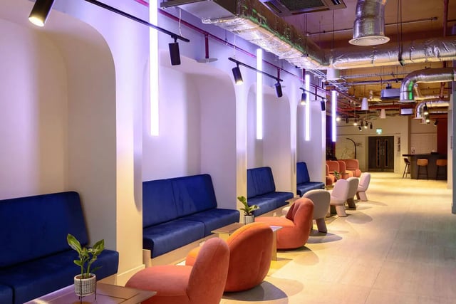 Blue sofas and orange chairs communal area at True Nottingham in Nottingham Student Accommodation